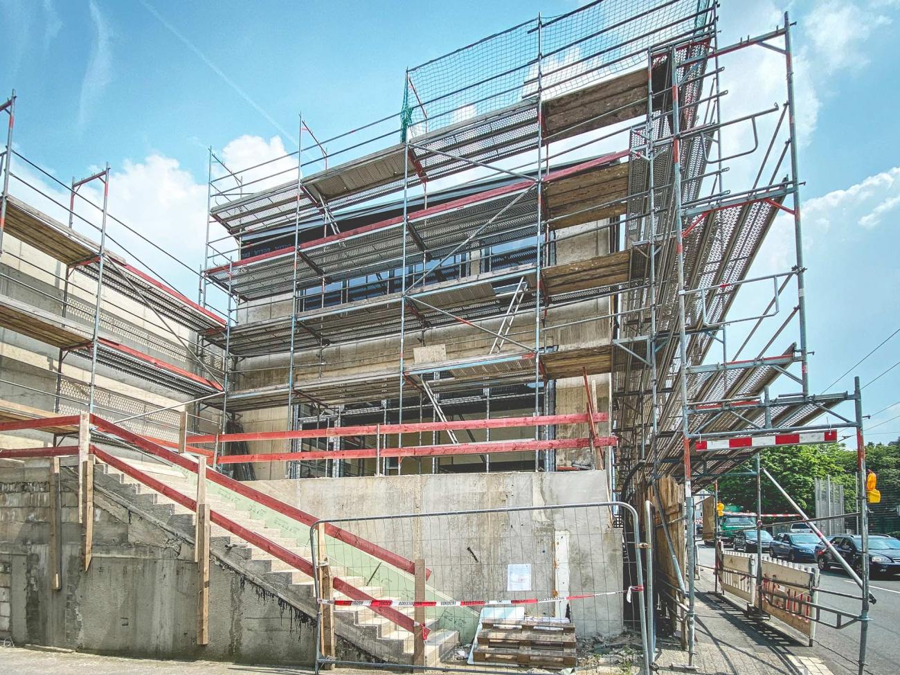 Blick auf den an der Straße gelegenen dreigeschossigen Neubau Sanierung Schulbau Bildungsbau Architekt Bonn Solingen